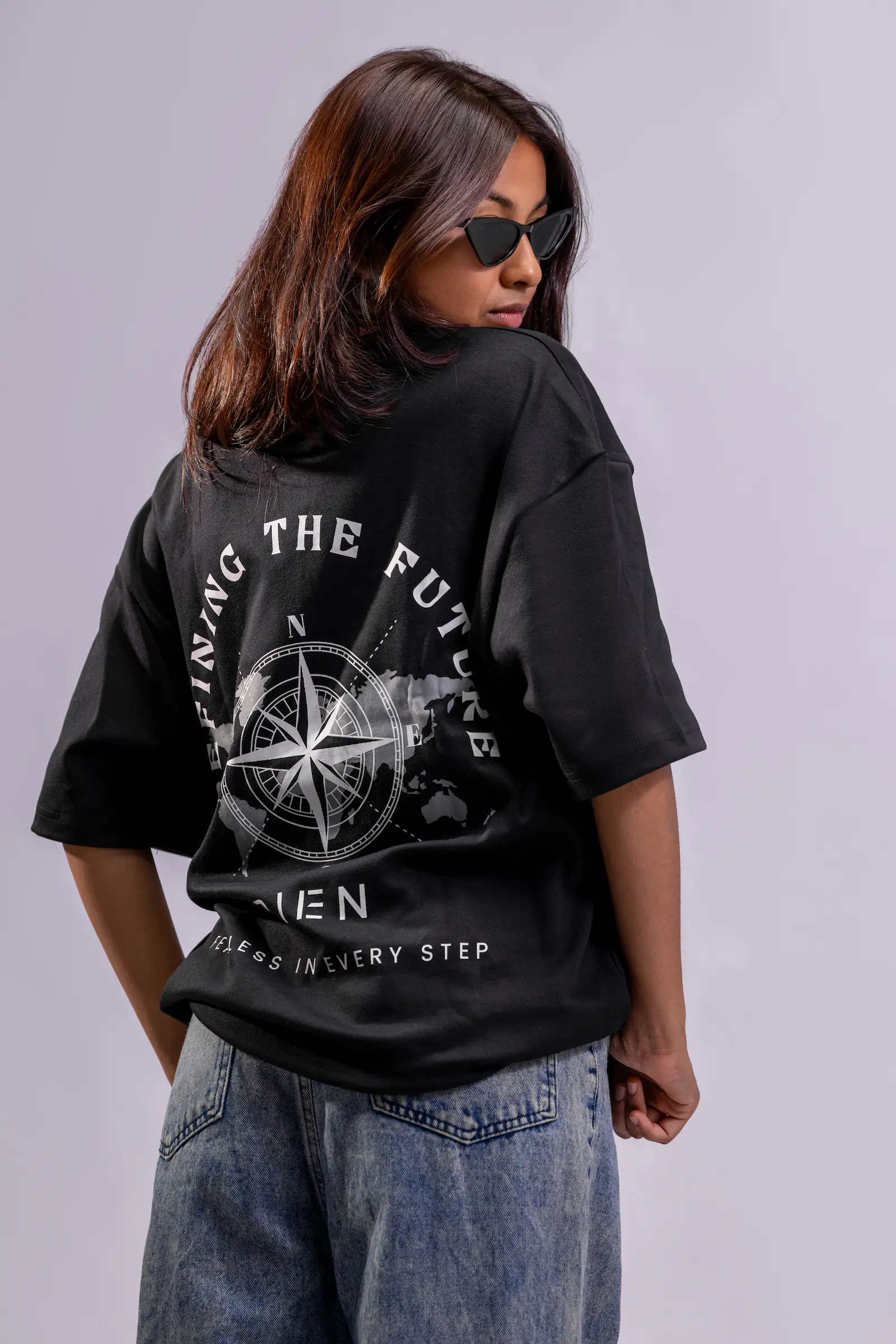 Defining The Future Oversized Tee Unisex in black, back view showing the compass and world map print