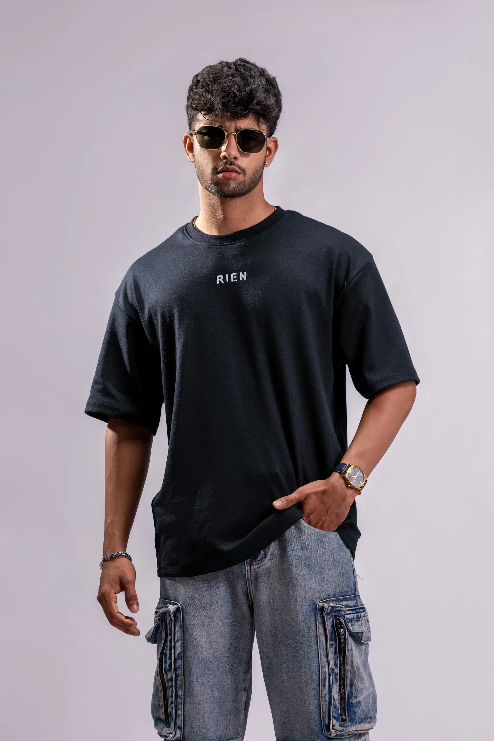 Defining The Future Oversized Tee Unisex in black, front view with RIEN chest logo