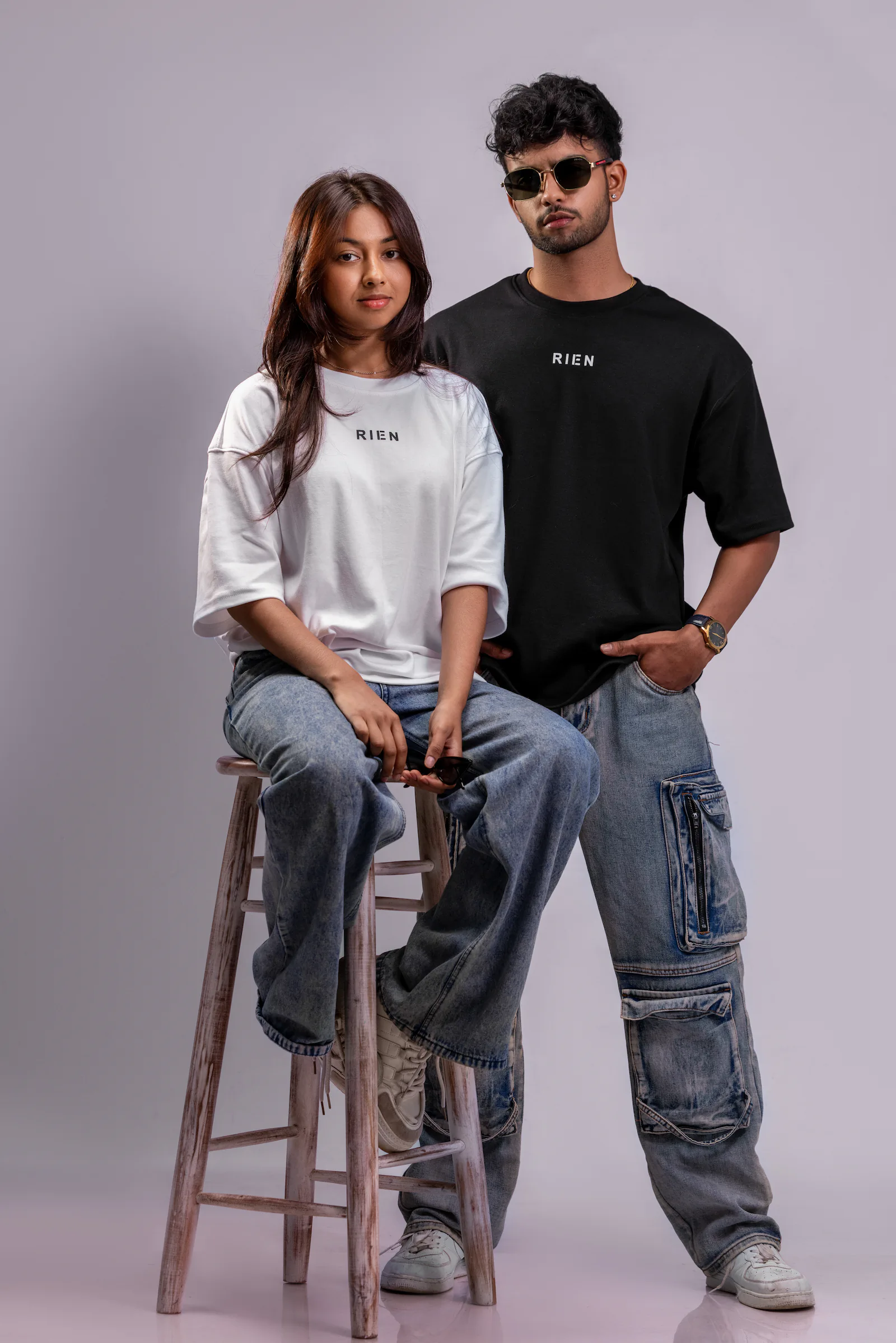 Defining The Future Oversized Tee Unisex in black and white, front view on a man and a woman