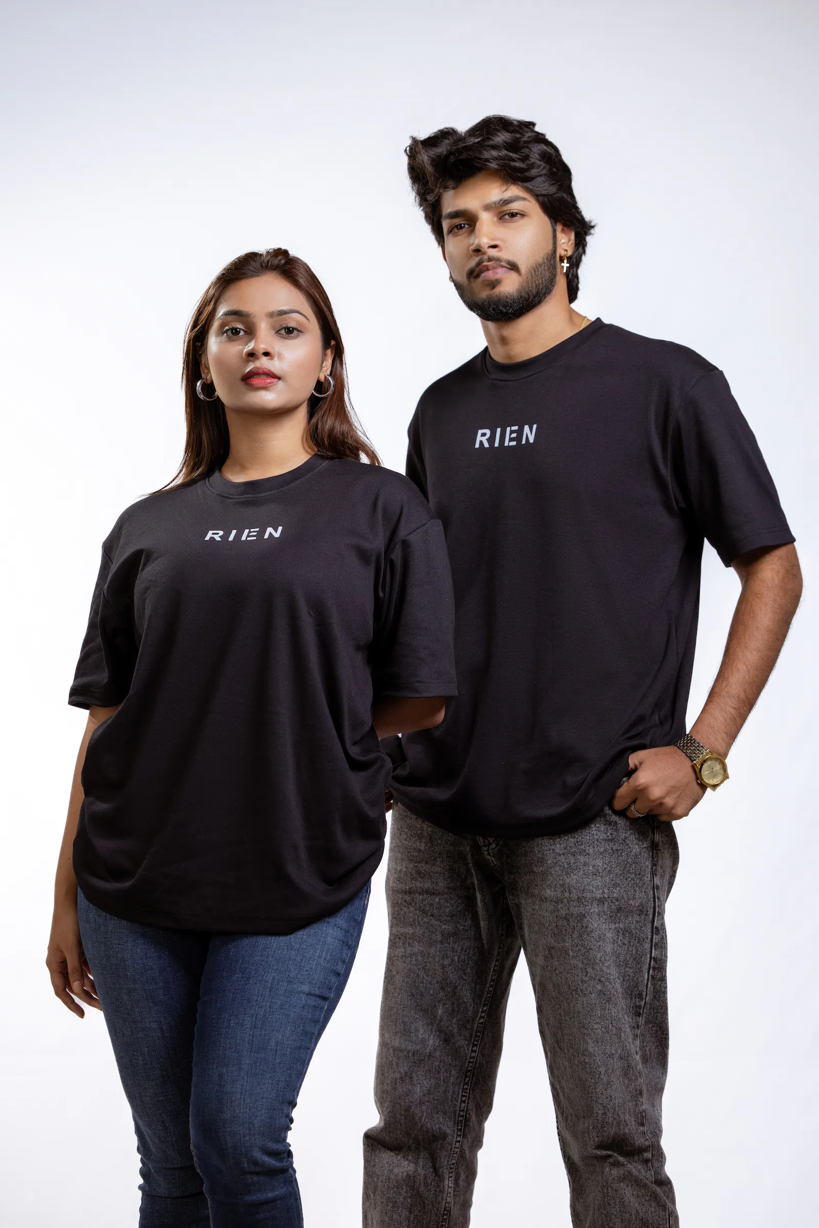 Rien Classic Oversized Tee in black, worn by a woman and a man
